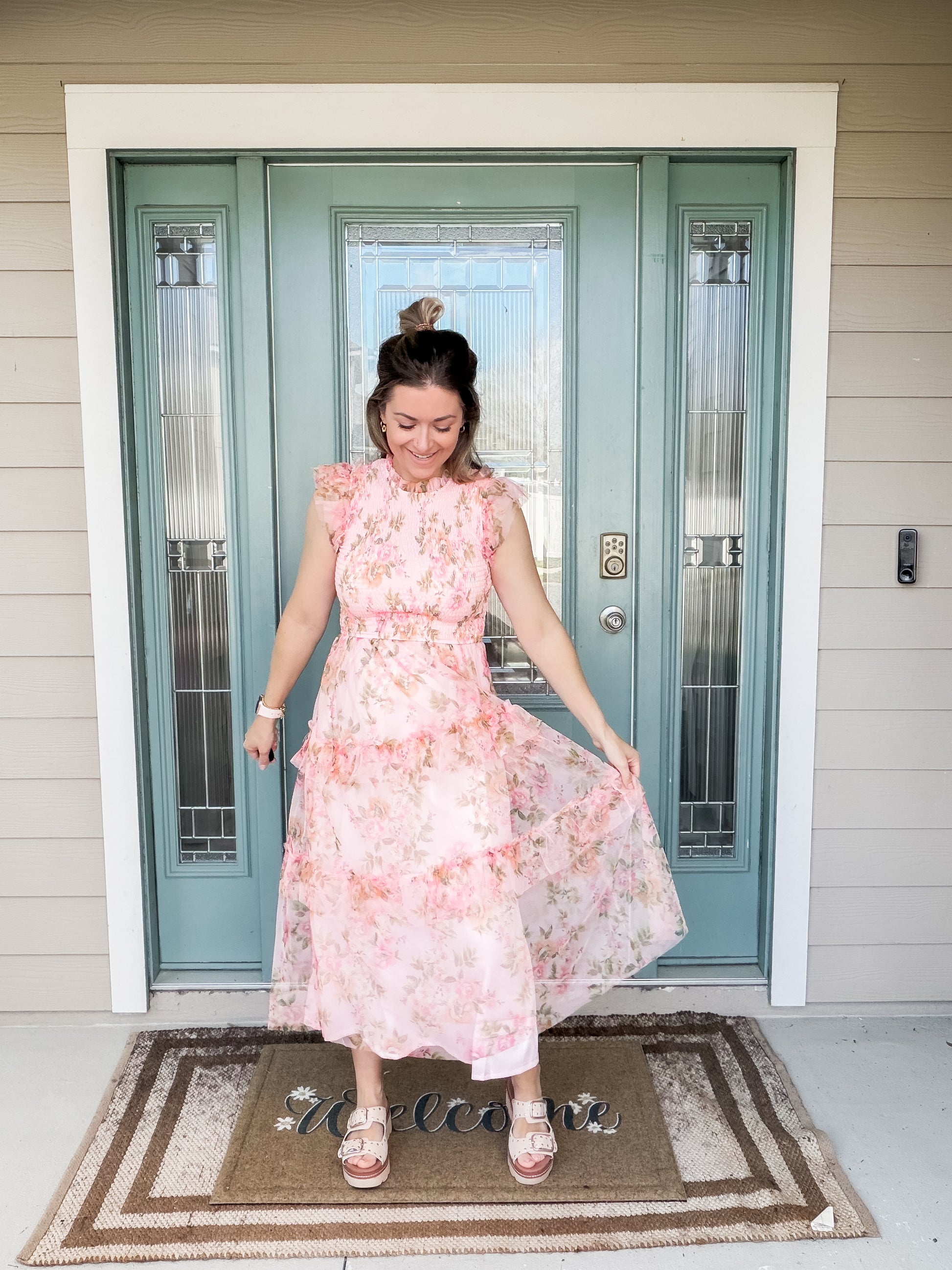 Woman in a pink floral tulle midi dress featuring slip skirt lining and tulle dress overlay. 