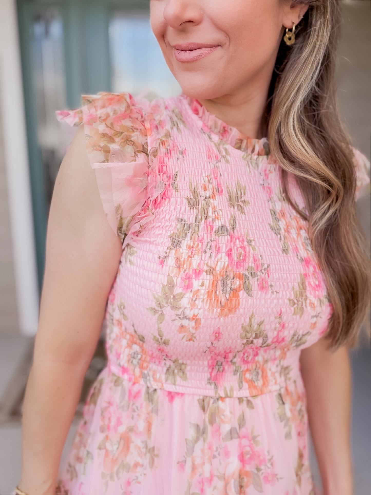 close up of floral pattern with tulle sleeve detail and tulle on neckline. 