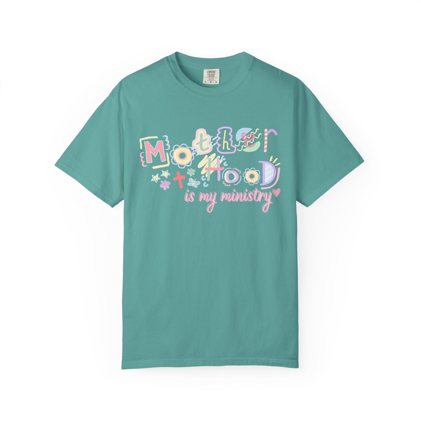 Teal t-shirt with colorful text  "motherhood is my ministry" design on a white background