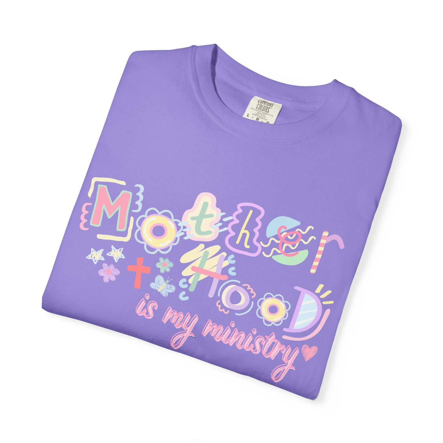 Folded purple t-shirt with colorful text design on a white background