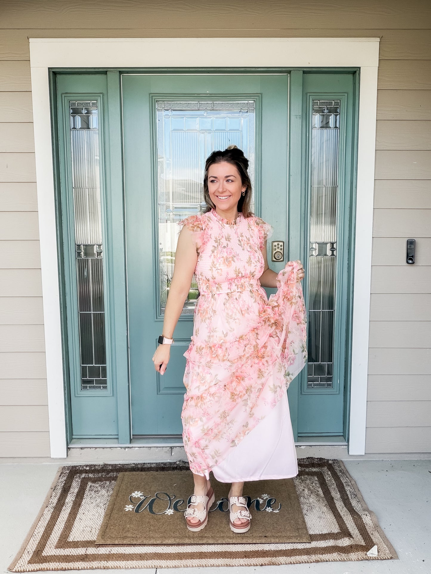Woman in a pink floral tulle midi dress featuring slip skirt lining and tulle dress overlay. 