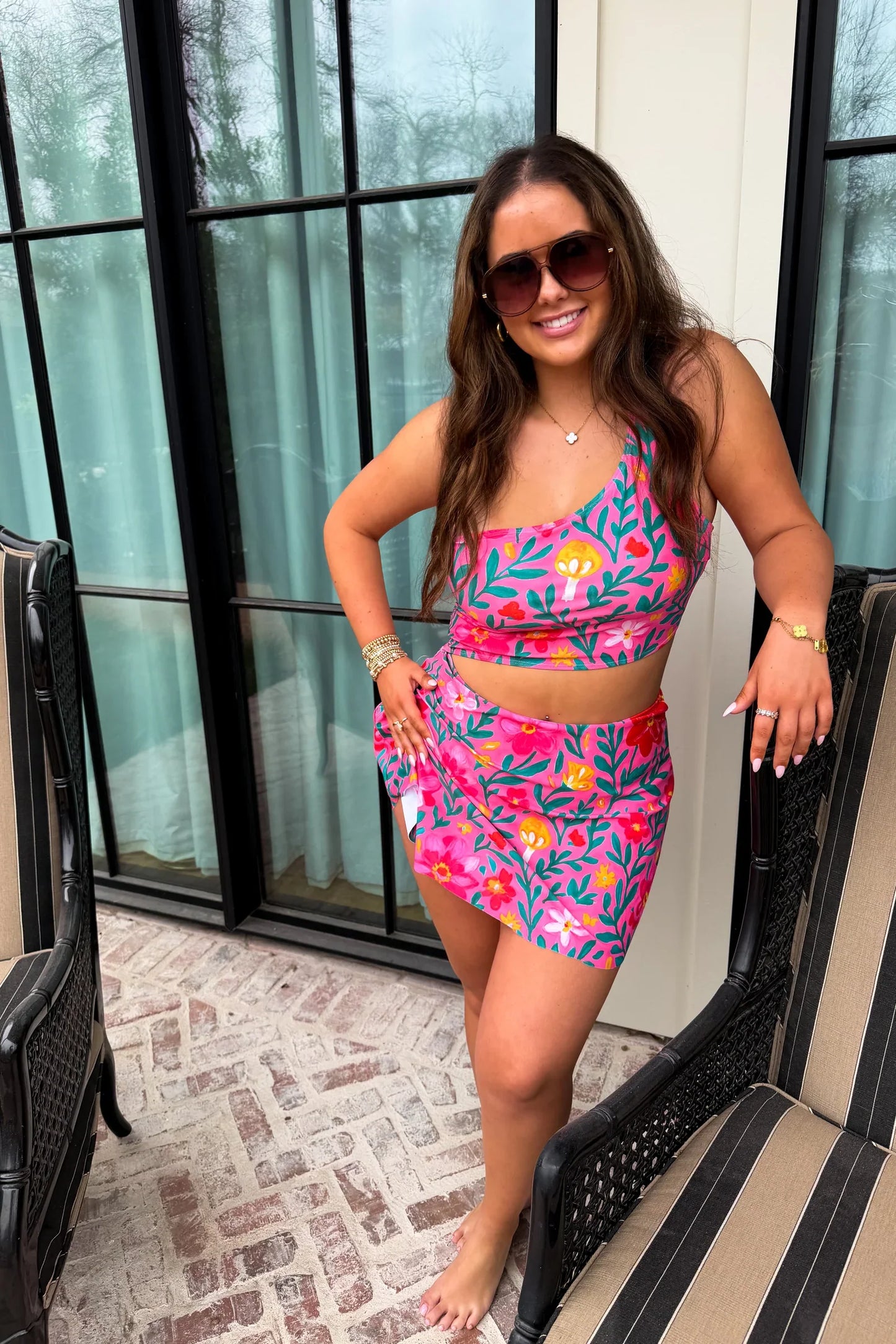 Woman wearing a colorful two-piece swimsuit on a patio