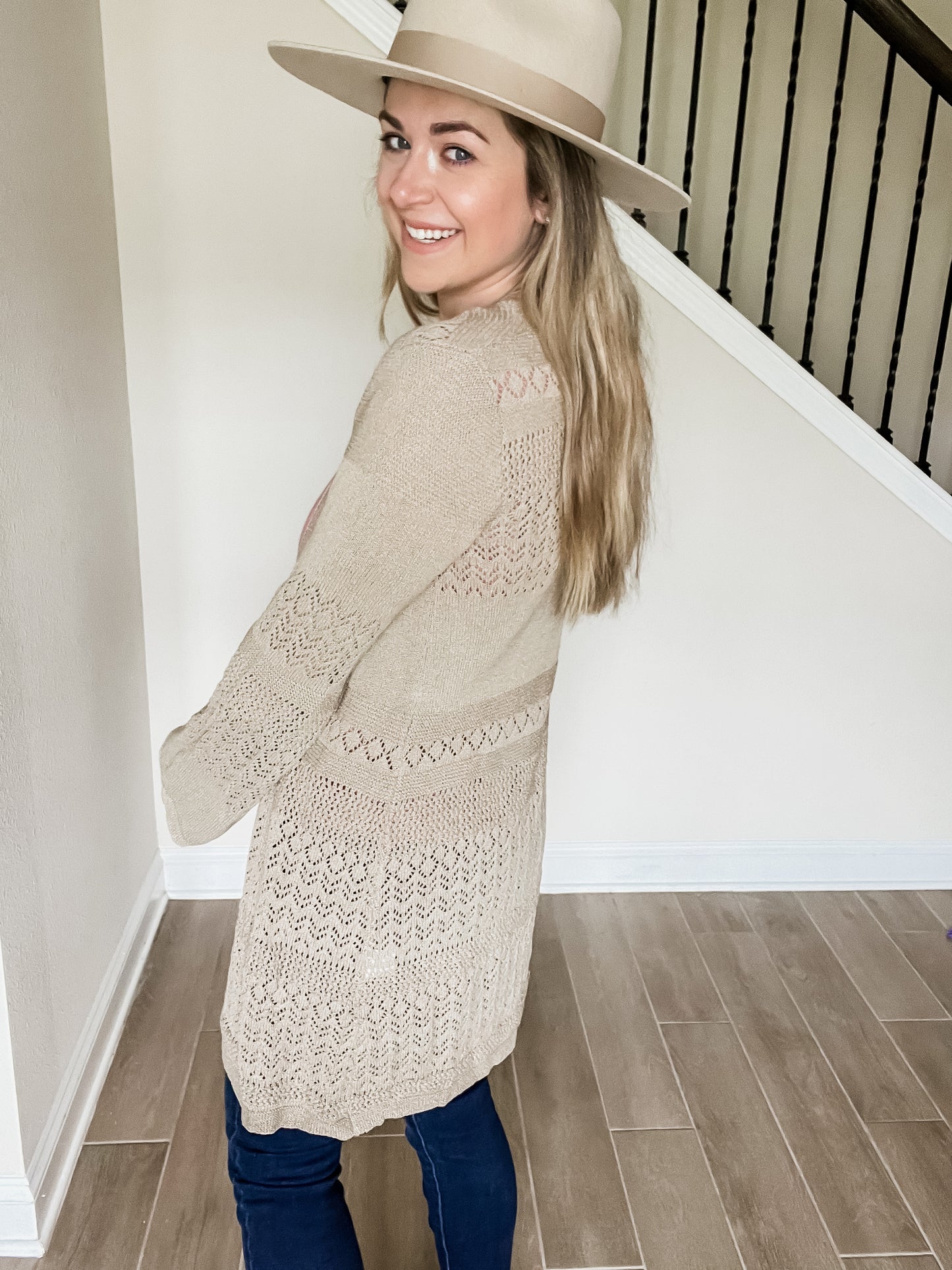 kindly knit cardigan in taupe color with elegant knitted material that is longer length side view. 