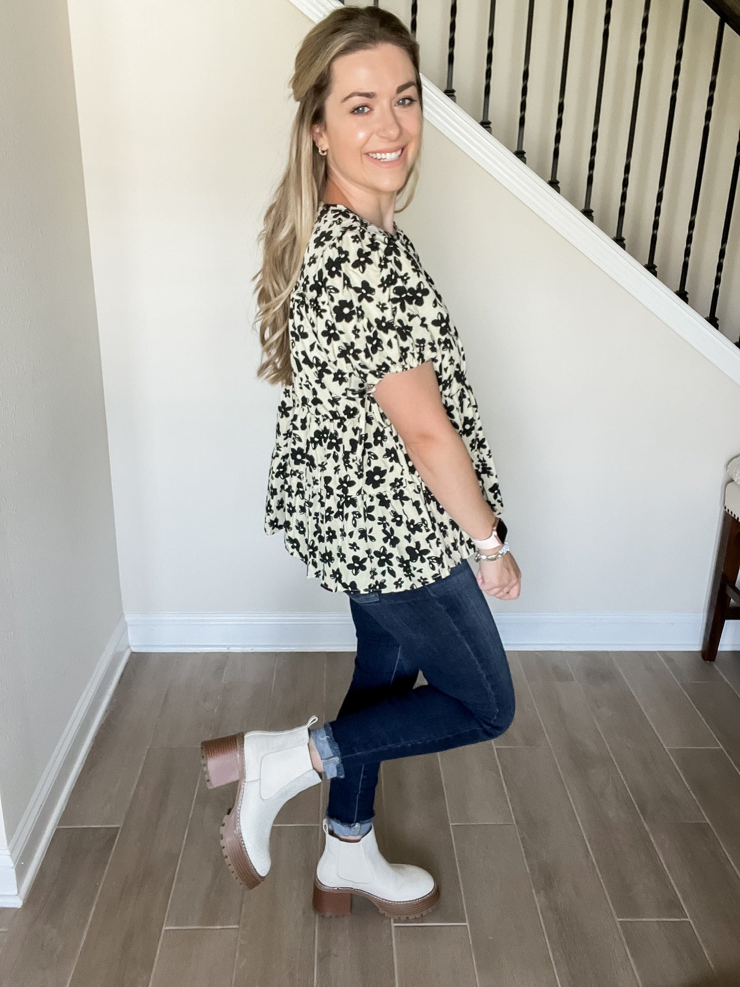 Blair flower blouse with black flowers and tan background with short sleeve tiered design. style with denim and boots